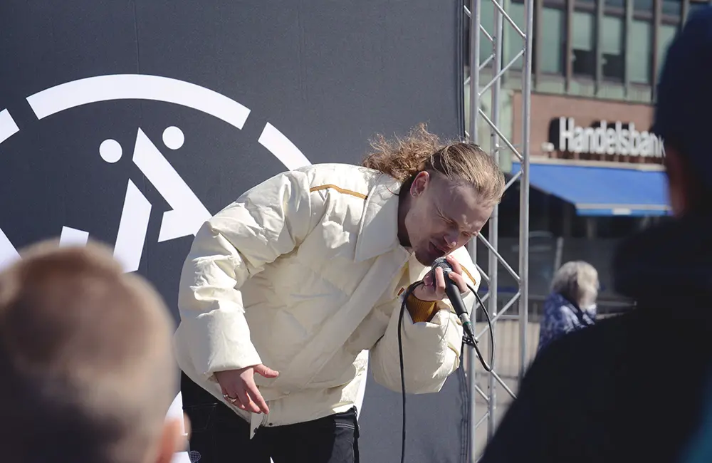 Artisten BB Amoré står på scenen och sjunger. 