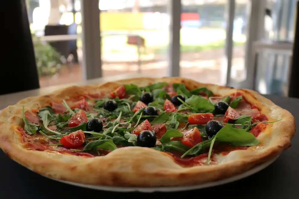 Pizza med tomat, oliver och ruccola